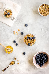 Oat flakes with honey and berries on table background top view