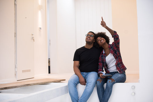 couple having break during moving to new house