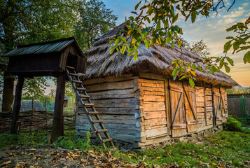 Ukrainian traditional village buildings at autumn.