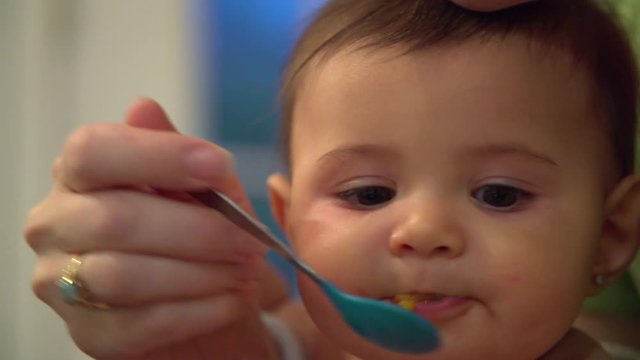 Happy baby enjoys being fed
