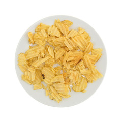 Top view of broken potato chips on a plate isolated on a white background.