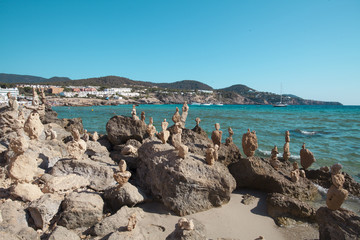 Fototapeta na wymiar Balanced stones on the beach of CalaTarida, Ibiza Island