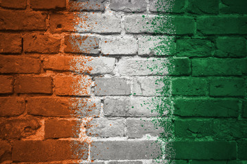 painted national flag of cote divoire on a brick wall