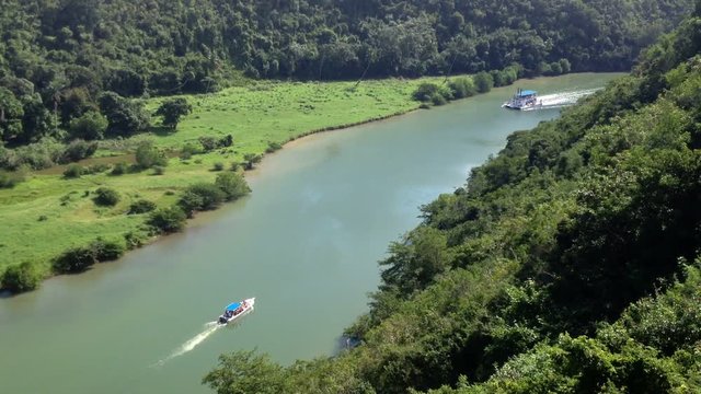 Passenger ship on a river in tropical forest top view