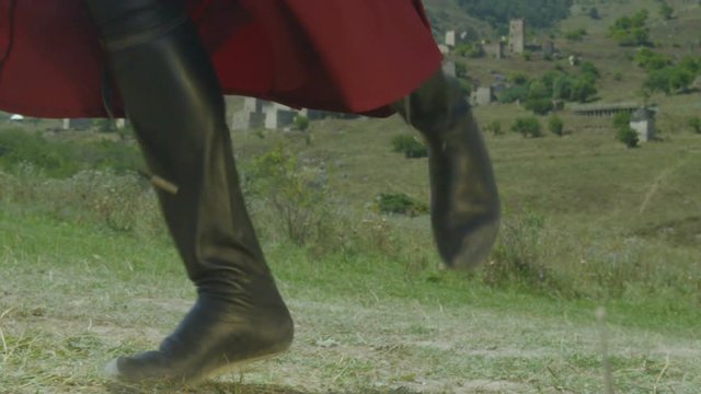 closeup ingushetian hillman in national clothes and black boots performs folk dance in slow motion