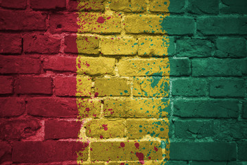 painted national flag of guinea on a brick wall