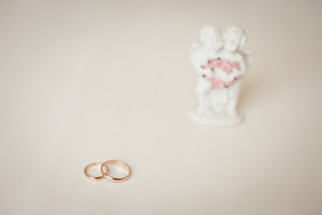 Wedding rings and Cupid statuette, wedding accessories