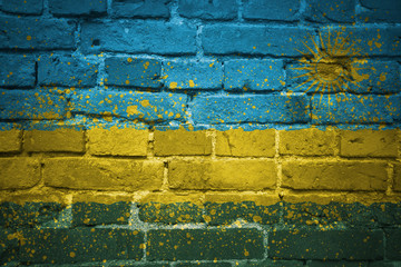 painted national flag of rwanda on a brick wall