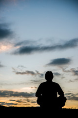 Yoga meditation by man silhouette.