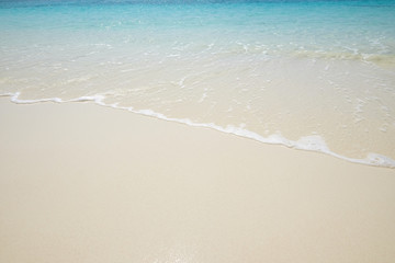 Fototapeta na wymiar Blue sea wave on sand beach. Summer holiday relax background wit