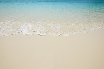 Fototapeta na wymiar Blue sea wave on sand beach. Summer holiday relax background wit