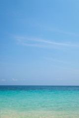 Blue sea wave on sand beach. Summer holiday relax background wit