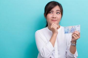 Asian woman planing to use fifty baht banknote