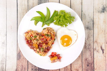 Chinese sausage fried rice and sunny egg in heart shapes.