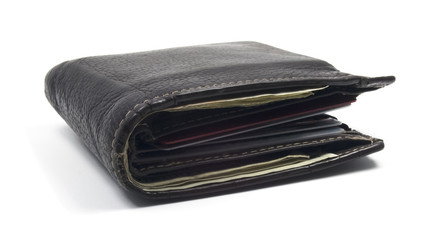 Isolated wallet filled cash and credit cards.