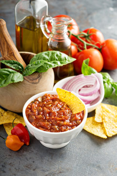 Homemade spicy tomato salsa with vegetables and olive oil