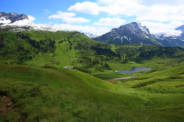 Fototapeta na wymiar Mountain landscape with green meadows and sunshine