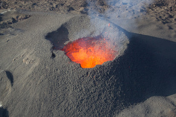 Erupting volcano, molten magma. Reunion island, France © cthoquenne
