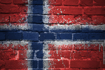 painted national flag of norway on a brick wall