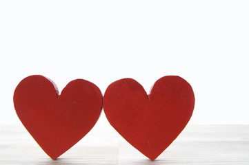 two hearts on white wooden background