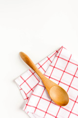 Wooden spoon and dish towel on white background