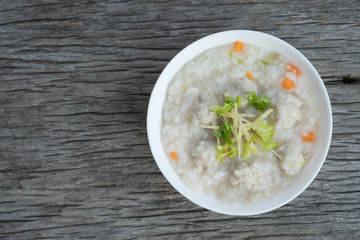 Traditional porridge rice with pork  in white bowl.