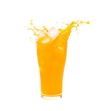 Orange juice splashing out of glass on Isolated white background.