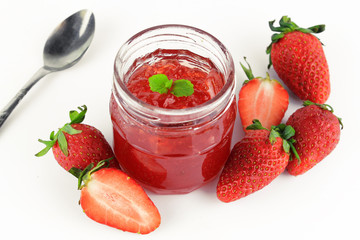 fresh strawberry jam in glass bottle with mint leaf