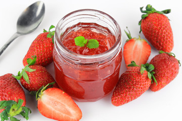 fresh strawberry jam in glass bottle with mint leaf