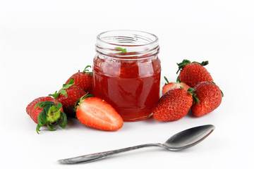 fresh strawberry jam in glass bottle with mint leaf