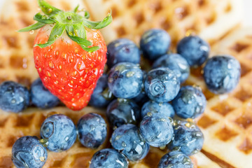 Blueberries and strawberry with honey on top of Fresh homemade w