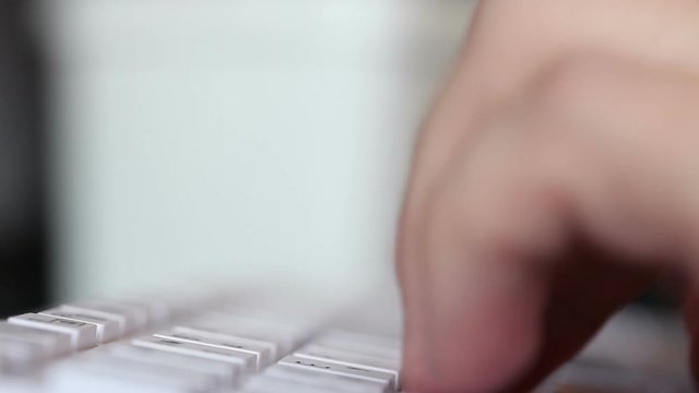 typing on a white keyboard. hands closeup