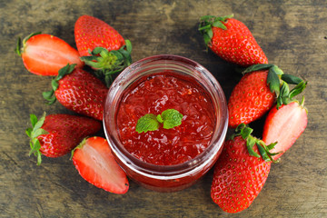 fresh strawberry jam in glass bottle with mint leaf