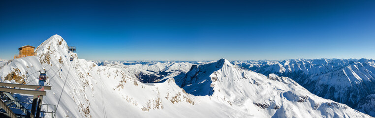 Sunny panoramic view of Austrian Alps from viewpoint of ski resort Zillertal Hintertuxer Glacier, Tirol, Austria.