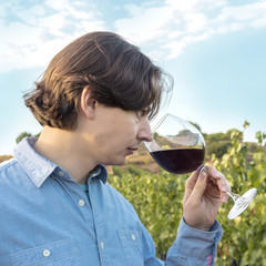 Winemaker tasting his wine in vineyard