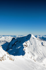 Fototapeta na wymiar Sunny view of Austrian Alps from viewpoint of ski resort Zillertal Hintertuxer Glacier, Tirol, Austria.