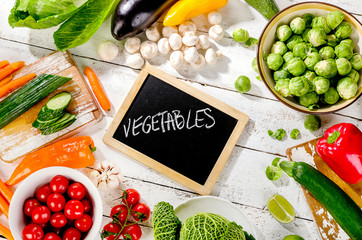 Raw organic vegetables  on a wooden background. Top view.