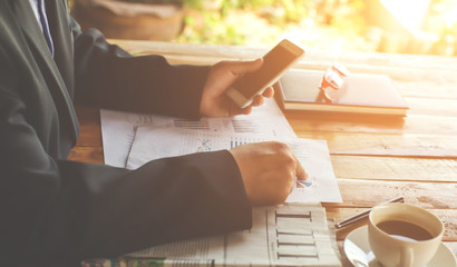 Business Male manager discussion ideas and writing business plan at workplace,man holding pens and papers for business data,notes documents,analysis chart at the table,vintage color,selective focus.