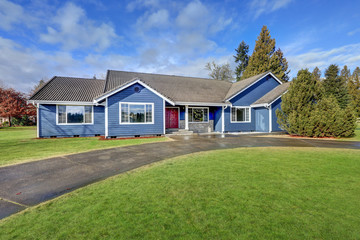 Beautiful blue rambler house with tile roof