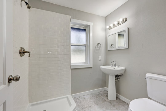 White bathroom interior with shower and washstand