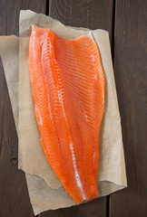 fresh trout fillet on wooden surface
