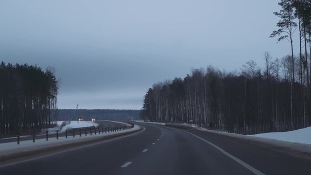 Winter road, winter forest, the view out of the car, car rides. 4k footage. 