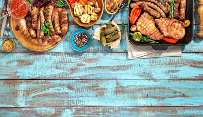 Variety of grilled food on the blue wooden table