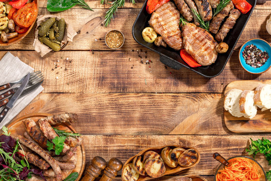 Frame Of Different Food Grill On The Wooden Table