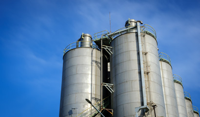 silos in petrochemical plant with blue sky