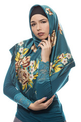 Female wearing a hijab, conservative fashion for muslims, middle east and eastern european culture.  She is isolated on a white background and looking worried of failure