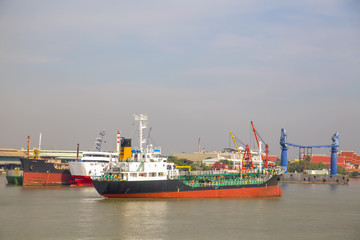 Fototapeta premium Logistic concept,Tanker Anchored mid-river to wait to port.