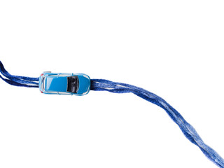 Toy car on blue yarn road. Where to go travel what to decide future choice. Copy space. Top view white background isolated