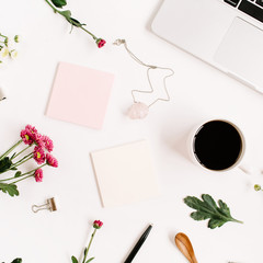 Top view home office table desk pattern. Workspace with laptop, wildflowers bouquet, coffee cup, feminine accessories and office stuff. Flat lay.