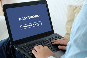 Man typing password on labtop screen background